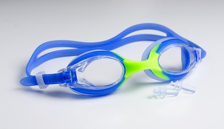 Blue glasses for swim on white background, ear plugs. Close upの写真素材