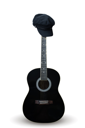 Black guitar with women's cap on. On white background isolated. Vertical photoの写真素材