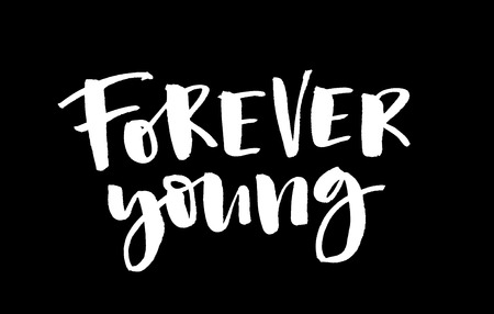 Forever young. White inscription on a black background. Handwritten text. Modern calligraphy. Inspirational quote.の写真素材