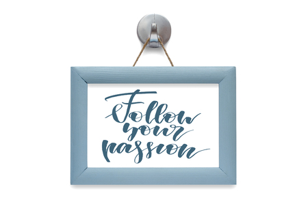 Follow your passion - motivational quote. Stylized lettering. Blue wooden frame. Isolated on whiteの写真素材