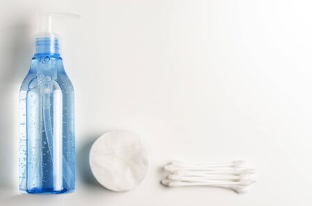 Womens makeup remover accessories. Gel in a transparent bottle, cotton buds, cotton pads. Copy space