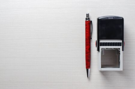 Lawyer or notary accessories. Stamp and fountain pen on the table