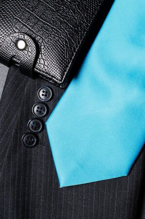 Blue mens necktie, jacket sleeve, and black wallet. Concept image of a successful business manの写真素材