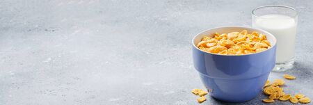 Corn flakes in a plate and milk in a glass. Healthy breakfast. Copy spaceの写真素材
