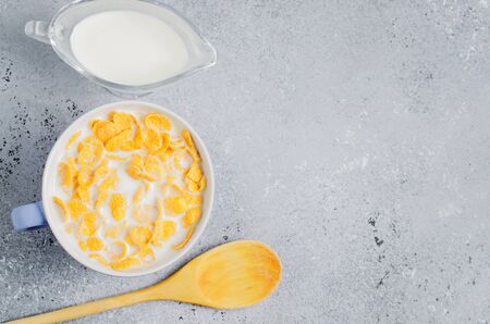 Corn flakes in milk. Blue Cup. Healthy and nutritious Breakfast. Copy space