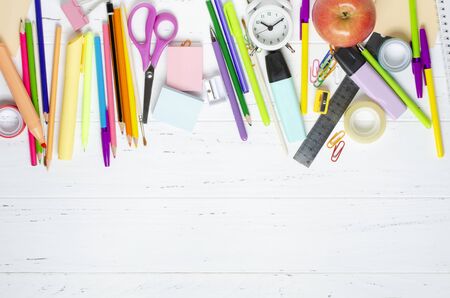 Children's accessories for study, creativity and office supplies on a white wooden background. Back to school concept. Copy space.の写真素材