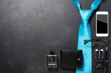 Mens accessories on a black concrete background. The concept of a successful modern man. Copy spaceの写真素材