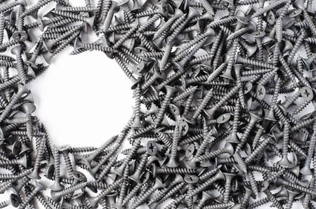 Lots of metal screws. White background. Copy spaceの写真素材