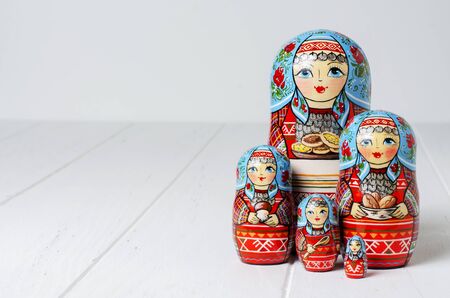 Five red matryoshka. Traditional Russian toy. Copy space. White wooden background.の写真素材