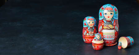 Five red matryoshka. Traditional Russian toy. Copy space. Black concrete background.の写真素材