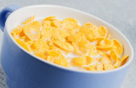 Corn flakes in milk. Blue Cup. Healthy and nutritious Breakfast. Copy spaceの写真素材