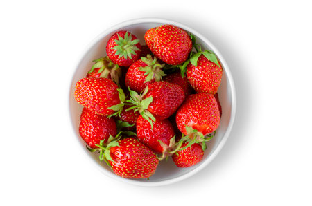 Strawberry. Ripe berries in a white plate. Isolated on whiteの写真素材