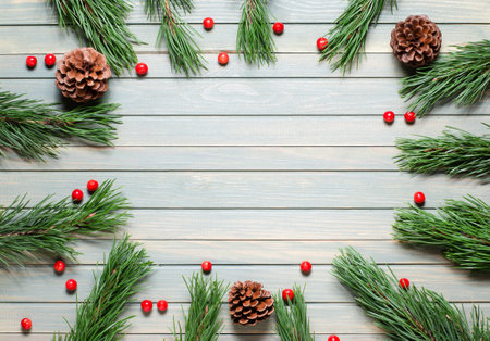 Christmas composition on a wooden background. Pine branches and cones. Flat lay, top view, copy space.の写真素材