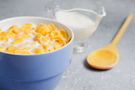 Corn flakes in milk. Blue Cup. Healthy and nutritious Breakfast. Copy spaceの写真素材