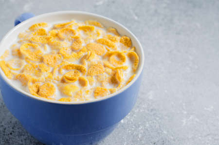 Corn flakes in milk. Blue Cup. Healthy and nutritious Breakfast. Copy space.の写真素材