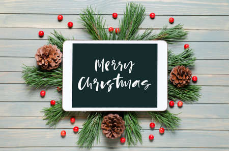 Christmas or new year background on a wooden background. Handwritten inscription on the gadget...