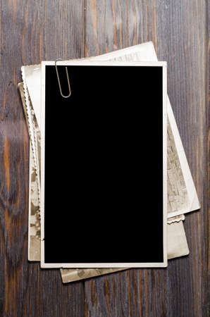 Old photos on a wooden brown background. Copy spaceの写真素材