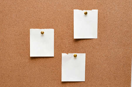 Blank paper notes are pinned to a cork board. Copy space.の写真素材