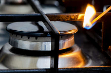 A match ignites the gas stove. Closeupの写真素材