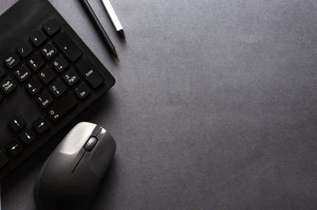 Computer keyboard and mouse on a black background. Copy spaceの写真素材