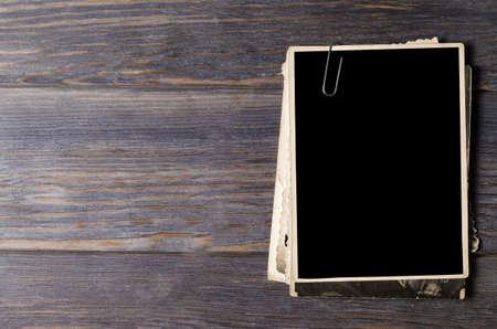 Old photos on a wooden brown background. Copy spaceの写真素材