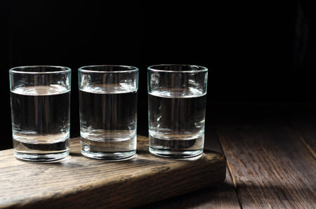 Glasses with Russian vodka on a brown wooden background. Copy spaceの写真素材