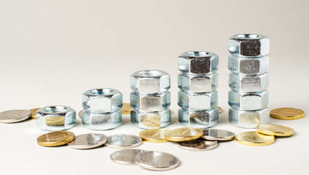 Coins and nuts closeup. The concept of inflation or production efficiency. Copy space