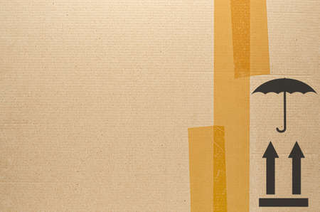 Brown tape on cardboard. Symbols of transportation. The concept of transporting things, sending a...