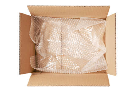 An open cardboard box with wrap. The concept of packaging parcels with fragile cargo. Isolated on white.の写真素材