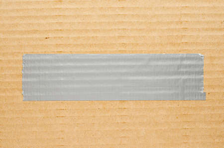 Grey metallic adhesive tape on cardboard. Copy spaceの写真素材