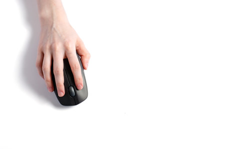 Computer mouse in the girls hand. White background.の写真素材