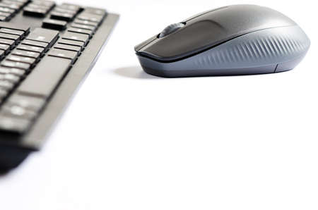 Computer mouse and keyboard on a white background. Copy space