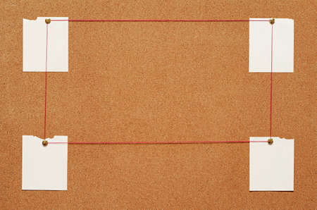 Blank paper notes are pinned to a cork board. The concept of detective investigation. Copy space.の写真素材