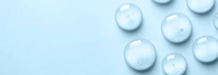 Blue drops of gel close-up. Cosmetic product for moisturizing the skin of the face or body. Copy...