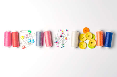 Accessories for sewing on a white background. Closeup. Copy space