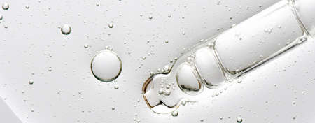 The texture of a cosmetic serum with a pipette closeup. Macrophotography