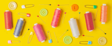 Sewing accessories on a yellow background. Closeup.の写真素材