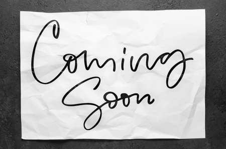 Coming soon. Lettering on crumpled white paper. Handwritten text. Inspirational quotes.