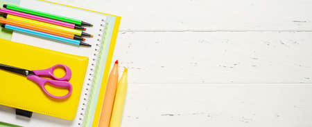 Childrens accessories for study, creativity and office supplies on a white wooden background. Back to school concept. Copy spaceの写真素材