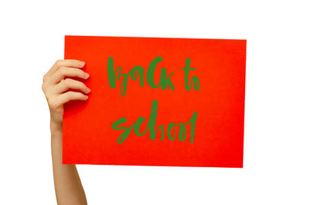 A colored poster in the girls hand. Handwritten inscription Back to school. Isolated on white