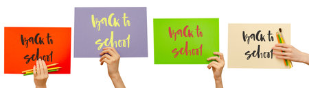 Colored posters in the girls hand. Set. Handwritten inscription Back to school. Isolated on whiteの写真素材