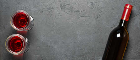 Red wine in a bottle. Black concrete background. Flat lay. Copy space.の写真素材