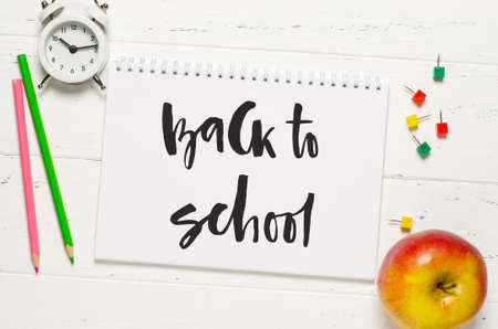 Childrens accessories for study, creativity and office supplies on a white wooden background....