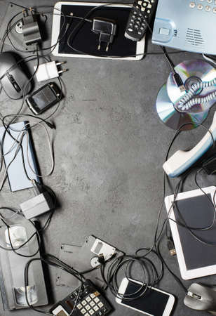 Old electronic devices on a dark background. The concept of recycling and disposal of electronic waste. Copy spaceの写真素材