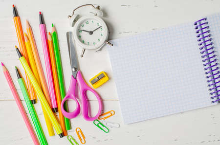 Childrens accessories for study, creativity and office supplies on a white wooden background. Back to school concept. Copy spaceの写真素材