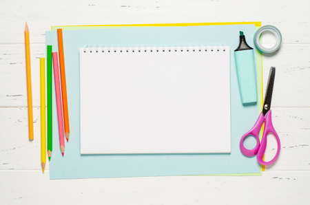 Childrens accessories for study, creativity and office supplies on a white wooden background. Back to school concept. Copy spaceの写真素材
