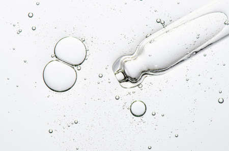 The texture of a cosmetic serum with a pipette closeup. Macrophotography