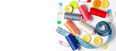 Accessories for sewing on a white background. Closeup. Copy space