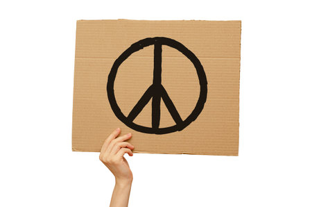 Poster against the war made of cardboard in hand. International day of Peace. Isolated on a white backgroundの写真素材