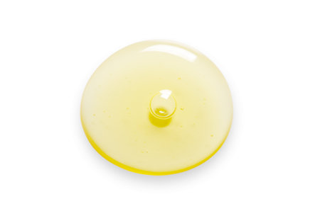 Yellow drops of gel close up. Cosmetic product for moisturizing the skin of the face or body. Isolated on a white background.の写真素材